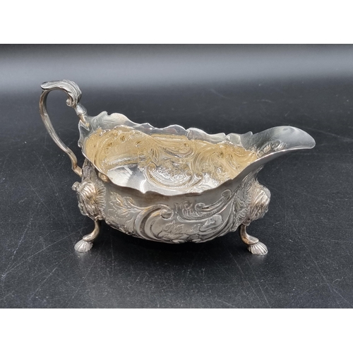 10 - An Elizabeth II Irish silver Sauce Boat with leafage scroll embossing, mask supports, Dublin 1968, 1... 