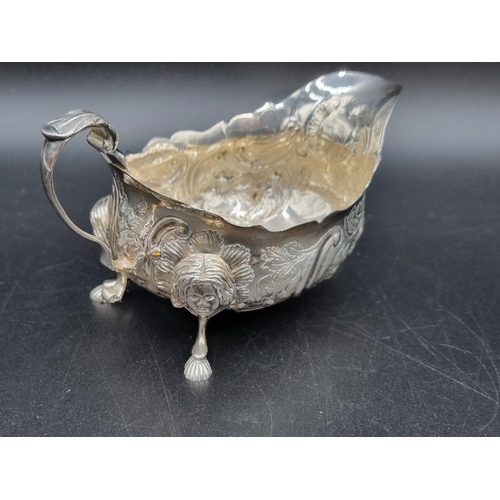 10 - An Elizabeth II Irish silver Sauce Boat with leafage scroll embossing, mask supports, Dublin 1968, 1... 