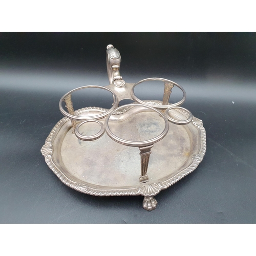 102 - A George III silver three bottle Cruet of kidney shape, leafage scroll handle, shell and gadroon rim... 