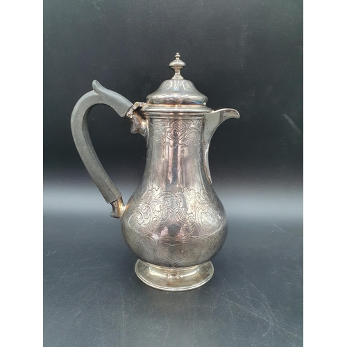 105 - A Victorian silver baluster Hot water Jug with scroll engraving and Somerset crest of ducal coronet ... 