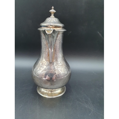 105 - A Victorian silver baluster Hot water Jug with scroll engraving and Somerset crest of ducal coronet ... 