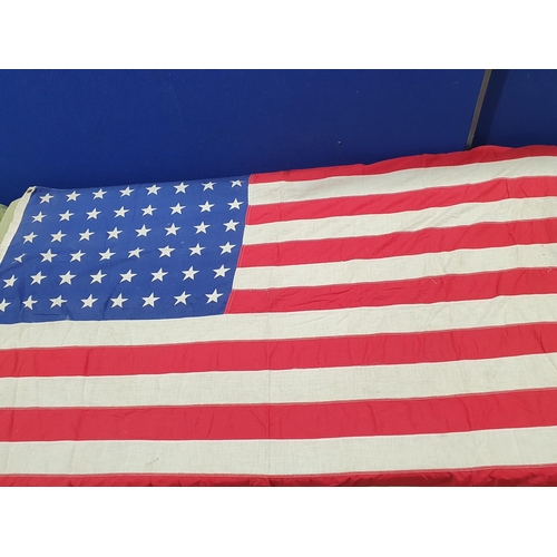 1054 - An antique American 'Stars and Stripes' Flag 4ft 8in W x 2ft 8in H, a Japanese 'Rising Sun' Flag 2ft... 