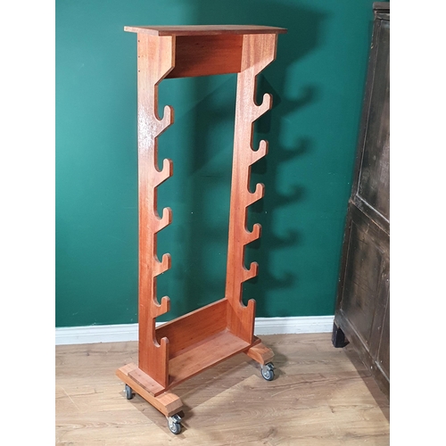 1063 - A mahogany Gun or Sword Rack on trolley wheels 5ft 7in H x 2ft 3in W