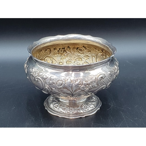 107 - A Victorian silver Sugar Bowl with floral and leafage scroll embossing, engraved Somerset crest with... 