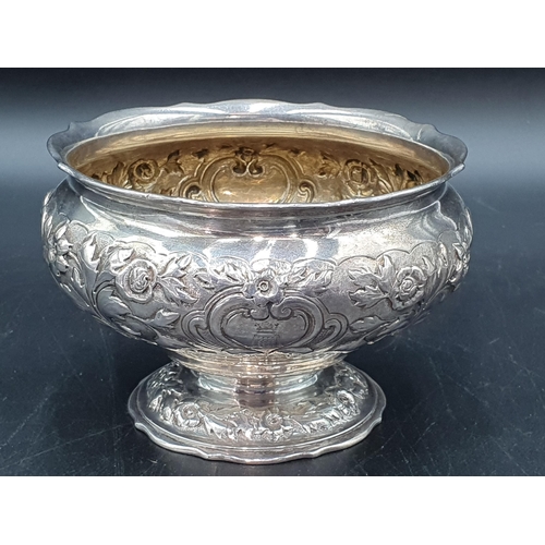 107 - A Victorian silver Sugar Bowl with floral and leafage scroll embossing, engraved Somerset crest with... 