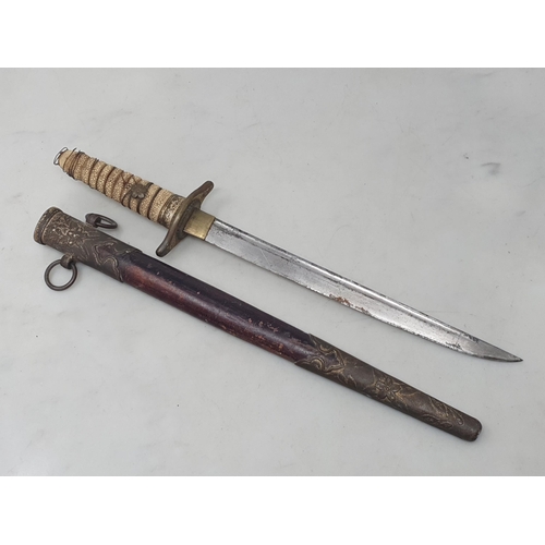 1083 - A Japanese Naval Dirk with single edged blade and shagreen wire bound grip in brass mounted leather ... 