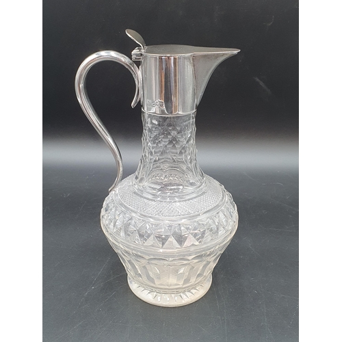 19 - A Victorian silver mounted cut glass Claret Jug with hinged lid and scroll handle,London 1900, maker... 