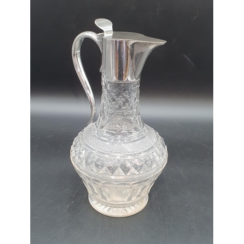 19 - A Victorian silver mounted cut glass Claret Jug with hinged lid and scroll handle,London 1900, maker... 