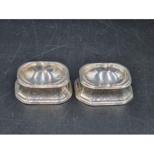 22 - A pair of early 18th century silver Trencher Salts with scroll decoration, possibly London 1717