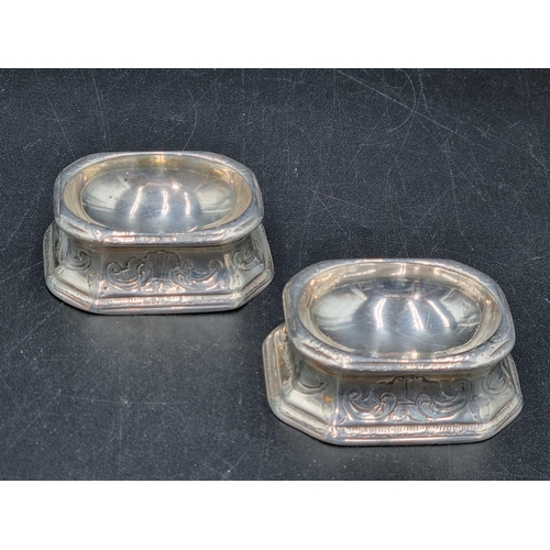 22 - A pair of early 18th century silver Trencher Salts with scroll decoration, possibly London 1717