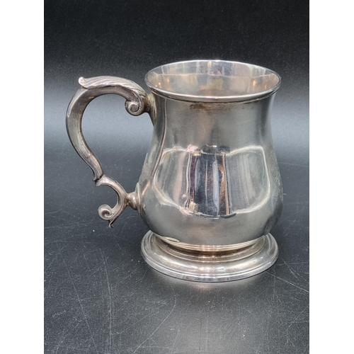 23 - A George II silver baluster Mug engraved coat of arms, leafage scroll handle, London 1748, maker: RB... 