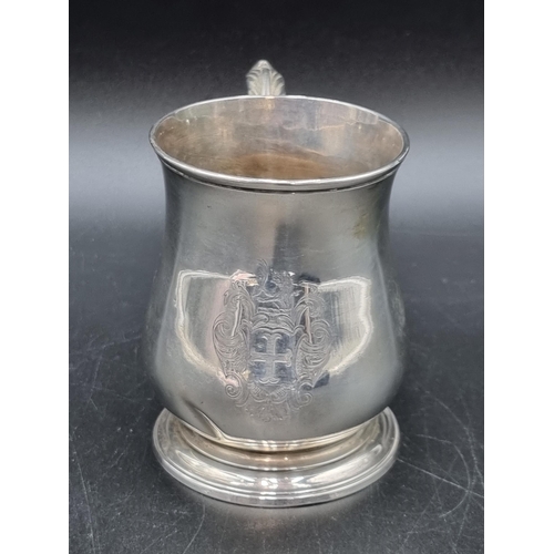 23 - A George II silver baluster Mug engraved coat of arms, leafage scroll handle, London 1748, maker: RB... 