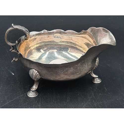 37 - A Victorian silver Sauce Boat with scroll handle on hoof feet, London 1891