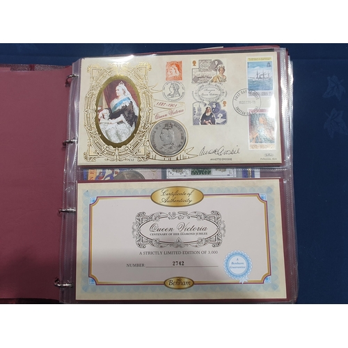 391 - An Album of First Day Covers and Covers with Coins to include a Victorian Crown, various One Pound, ... 