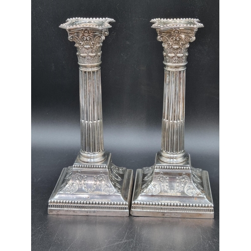 40 - A pair of Edward VII silver Candlesticks with fluted columns, corinthian capitals on beaded square b... 