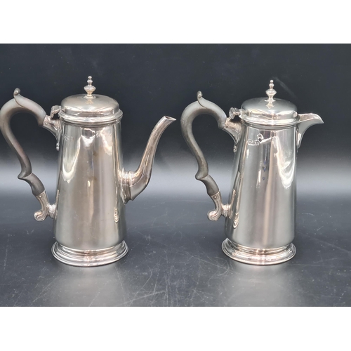 44 - A George V silver Coffee Pot and Hot Water Jug of tapering form with ebonised scroll handles, London... 