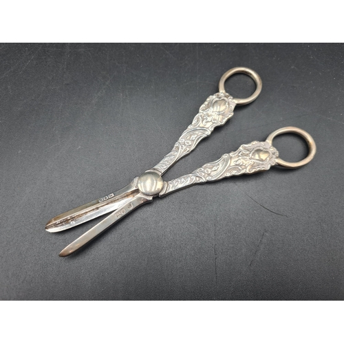 45 - A pair of Victorian silver Grape Scissors with floral and scroll design, London 1899, in original fi... 