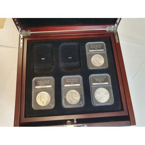 472 - A fitted Cabinet containing a collection of US silver Dollars and Rounds, presented in PCS Slabs con... 