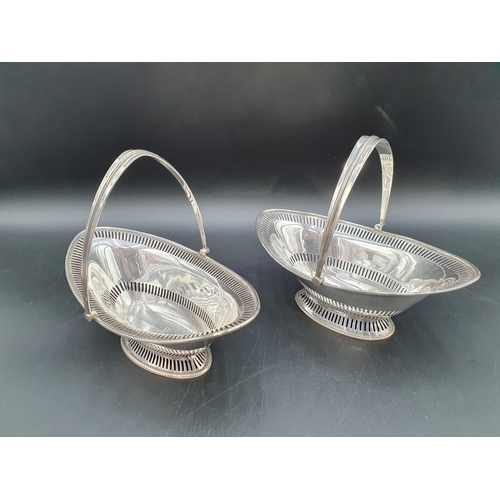 5 - A near pair of silver pierced oval Baskets with swing handles, London 1909 & Sheffield 1915, 390gms