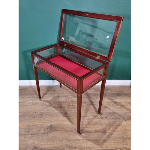 533 - An Edwardian inlaid mahogany table Display cabinet with glazed box top on tapering legs and casters,... 