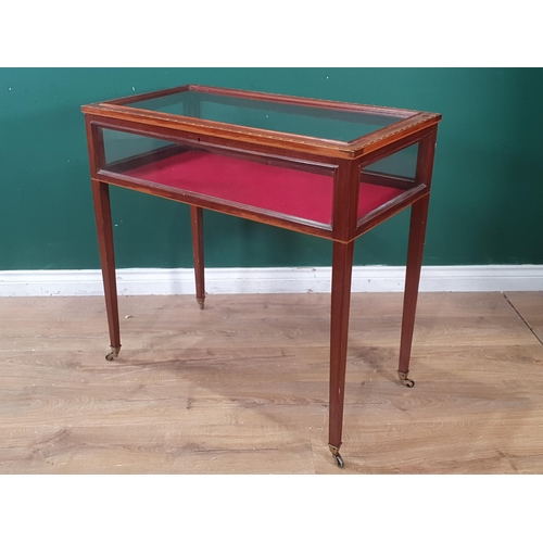 533 - An Edwardian inlaid mahogany table Display cabinet with glazed box top on tapering legs and casters,... 