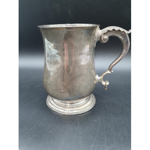 54 - A George III silver baluster Pint Mug with leafage scroll handle, London 1765