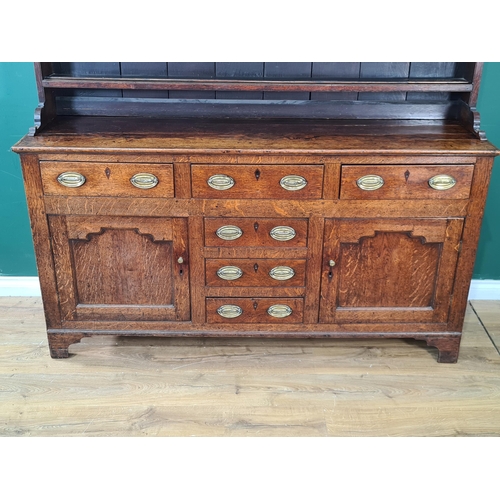 547 - An early 19th Century oak Dresser and Rack, the base fitted six drawers and two cupboard doors raise... 