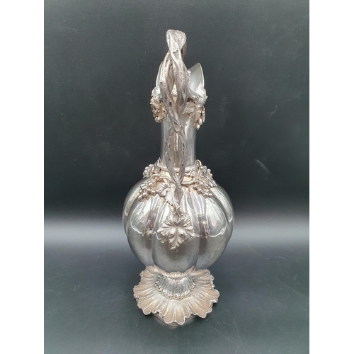 55 - A William IV silver Claret Jug and Stopper with fruiting vine decoration and entwined handle on fine... 