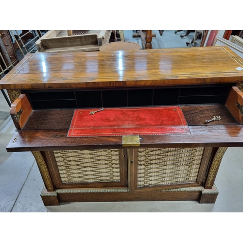 554 - A Regency brass inlaid rosewood Secretaire Cabinet with a fitted frieze drop front drawer above a pa... 