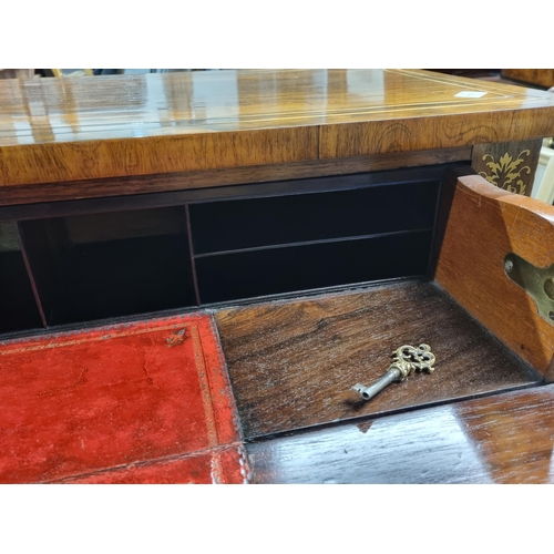 554 - A Regency brass inlaid rosewood Secretaire Cabinet with a fitted frieze drop front drawer above a pa... 