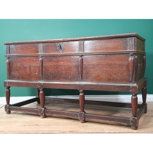 557 - An antique oak Coffer on Stand with moulded hinged cover and fitted two candle boxes to the interior... 