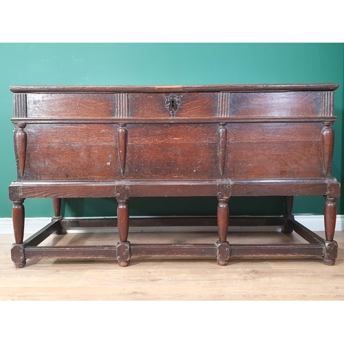 557 - An antique oak Coffer on Stand with moulded hinged cover and fitted two candle boxes to the interior... 