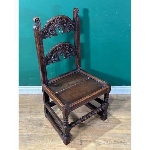 559 - A 17th Century oak Derbyshire Chair with two scroll carved back rails, raised upon ball and fillet t... 