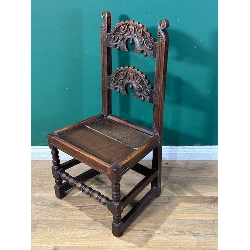 559 - A 17th Century oak Derbyshire Chair with two scroll carved back rails, raised upon ball and fillet t... 