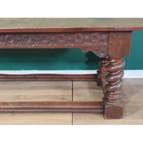 560 - A large, old, oak Refectory Table, the three-plank rectangular cleated top above carved scroll flora... 