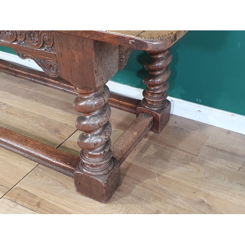 560 - A large, old, oak Refectory Table, the three-plank rectangular cleated top above carved scroll flora... 