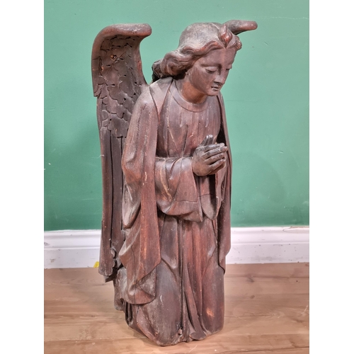 563 - An 18th Century carved walnut winged Roof Angel wearing robes, A/F, 2ft 2