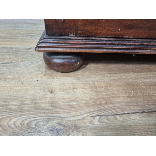 565 - An oak Cupboard fitted pair of geometric moulded cushion doors raised on bun feet by John Nethercott... 