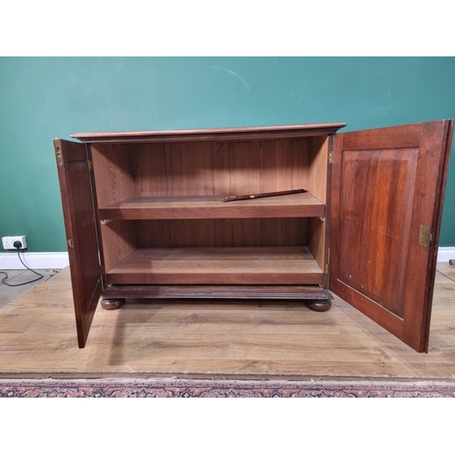 565 - An oak Cupboard fitted pair of geometric moulded cushion doors raised on bun feet by John Nethercott... 