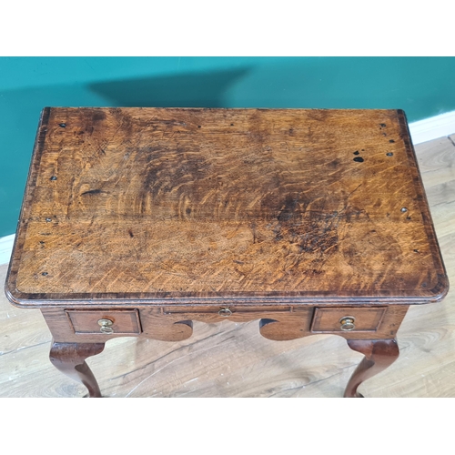 582 - A Georgian oak and crossbanded Lowboy with moulded top and fitted three drawers around a shaped frie... 