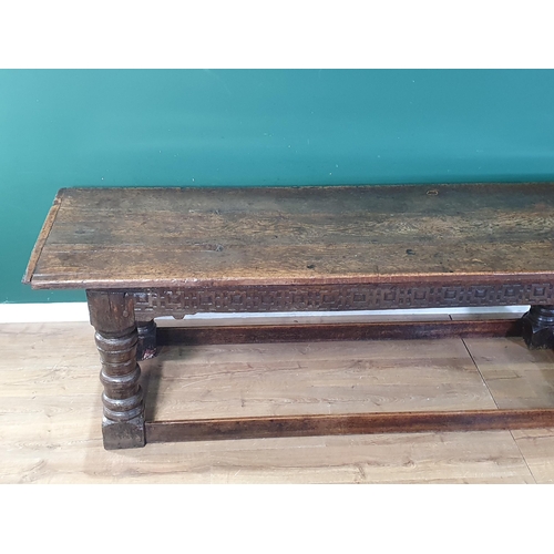 590 - A 17th Century oak Refectory Table with cleated thick three plank top above carved frieze to one sid... 