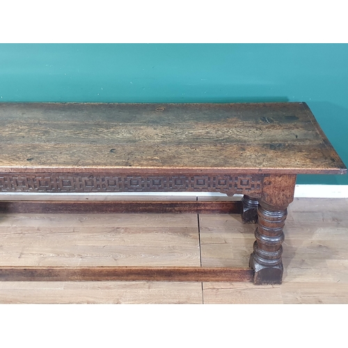 590 - A 17th Century oak Refectory Table with cleated thick three plank top above carved frieze to one sid... 