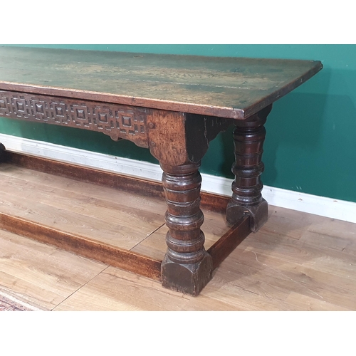 590 - A 17th Century oak Refectory Table with cleated thick three plank top above carved frieze to one sid... 