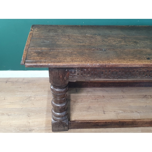 590 - A 17th Century oak Refectory Table with cleated thick three plank top above carved frieze to one sid... 