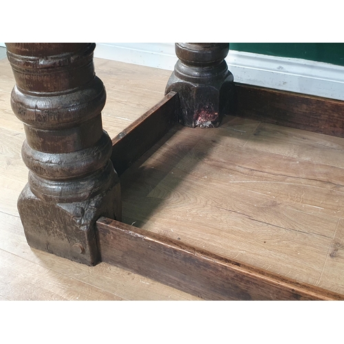 590 - A 17th Century oak Refectory Table with cleated thick three plank top above carved frieze to one sid... 