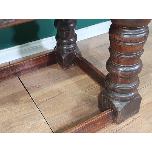 590 - A 17th Century oak Refectory Table with cleated thick three plank top above carved frieze to one sid... 