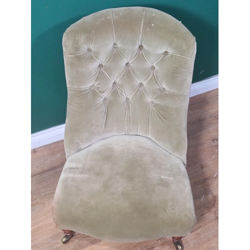 595 - A Victorian Occasional Chair with mustard upholstery on turned front legs and casters, the rear left... 