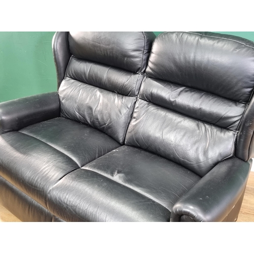 597 - A Designer black leather Settee which can be divided to use as two chairs.