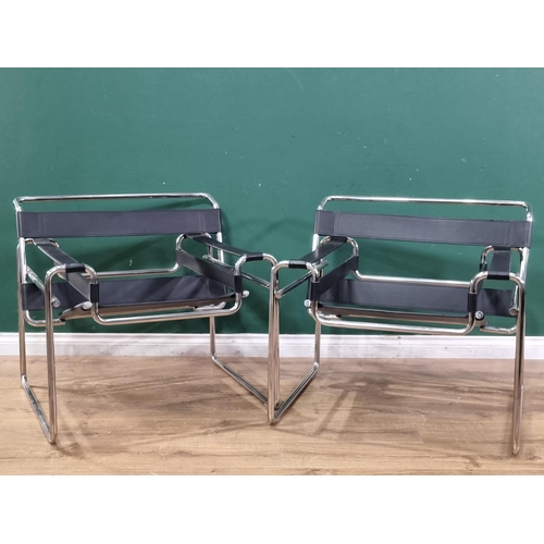 598 - A pair of Le Corbusier style low Armchairs