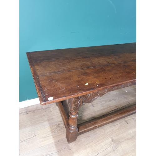 601 - A 17th Century oak Refectory Table with cleated three plank top above leafage arcade carved frieze r... 